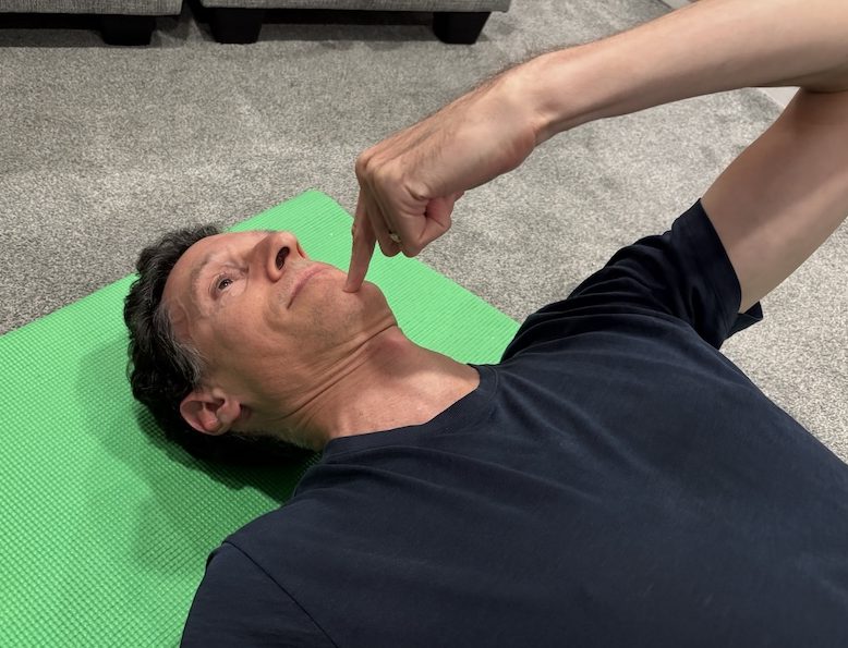 Neck retraction exercise performed during thoracic traction setup.
