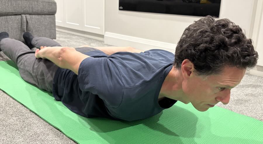 Patient drawing shoulder blades back and down during scapular retraction.