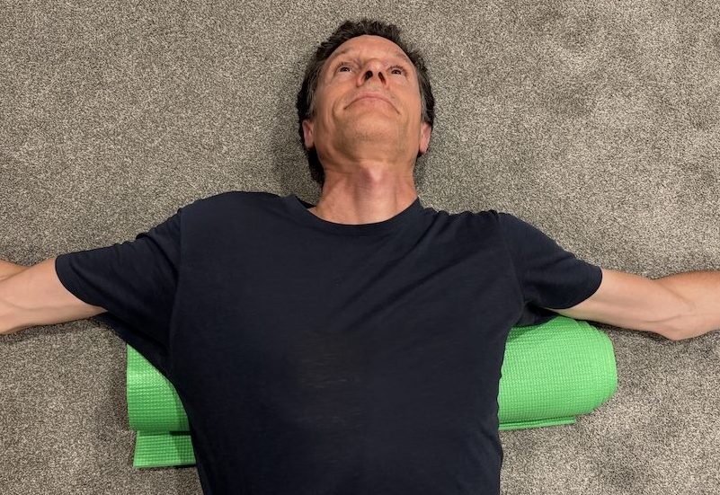 Mid-back extension position during thoracic traction exercise for posture correction Toronto.