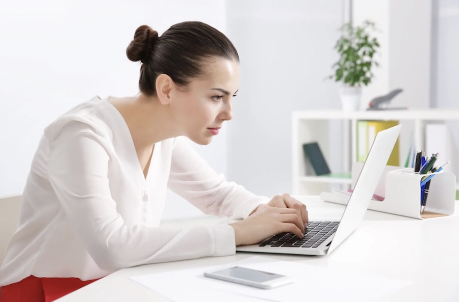 Poor desk posture causing neck strain and increased pressure on cervical nerves
