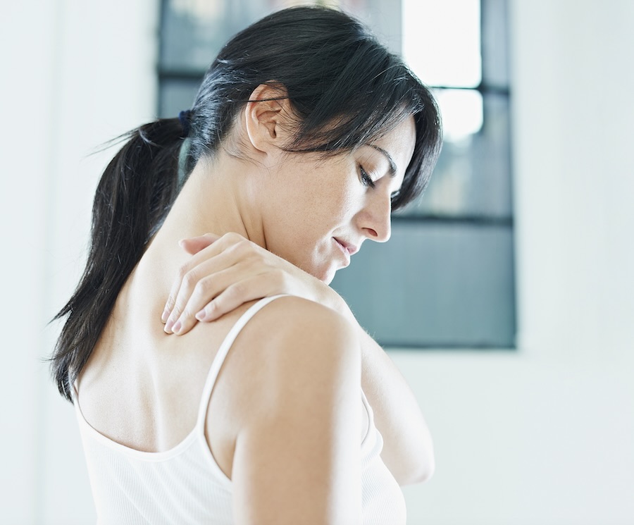 Woman experiencing neck pain radiating into the shoulder and upper arm